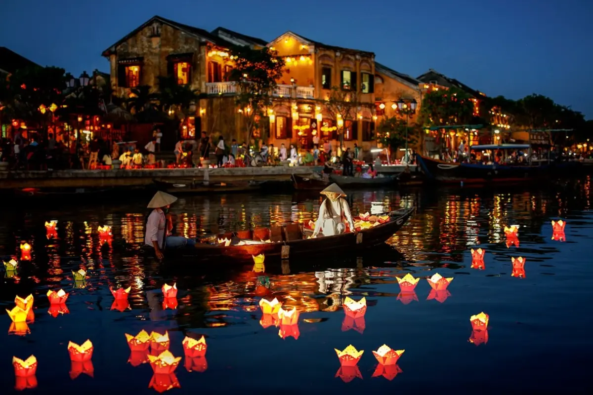 Lanterns reflecting on the river at night in Hoi An — Vietnam Honeymoon Journey
