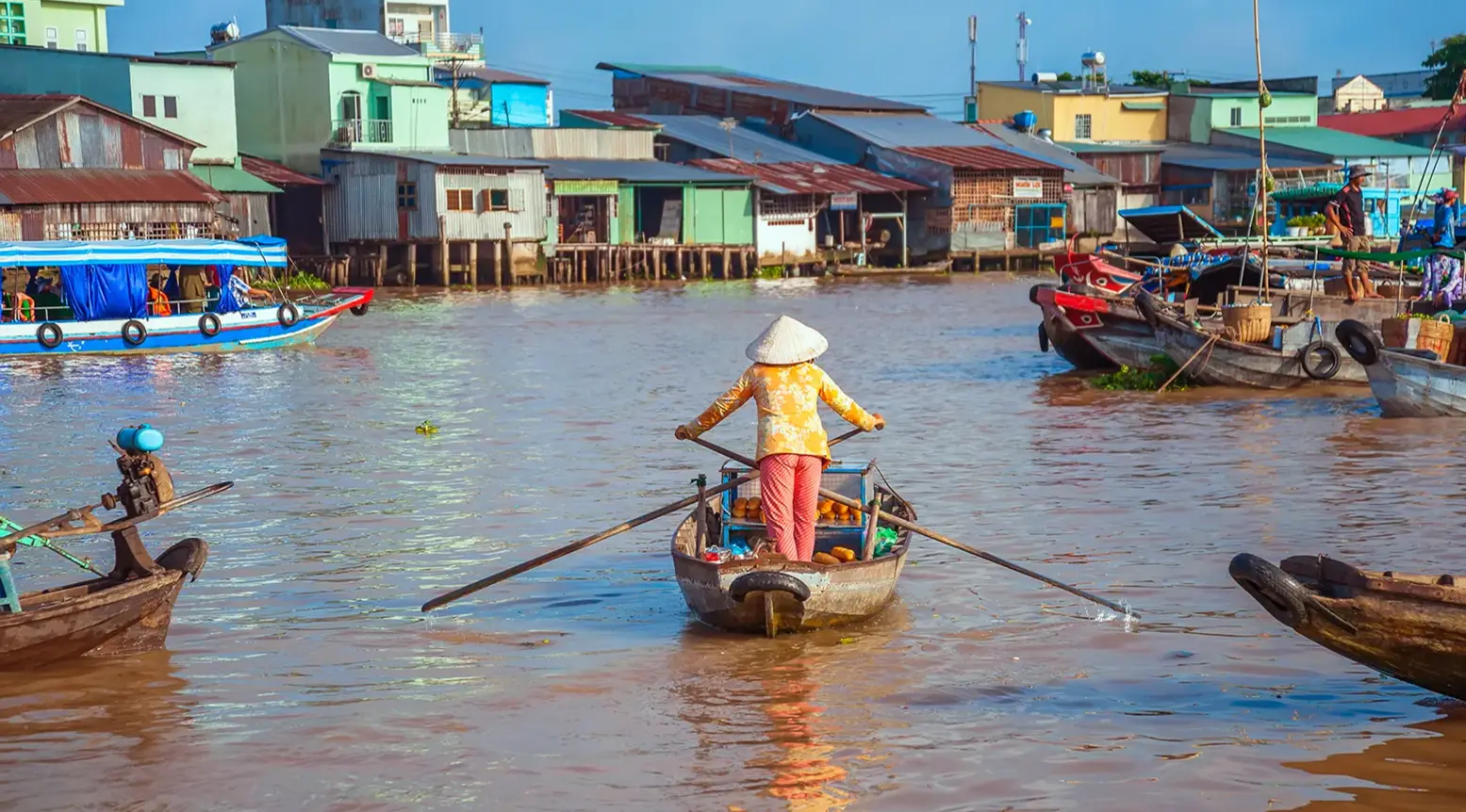 Woman rowing a sampan on the Mekong Delta